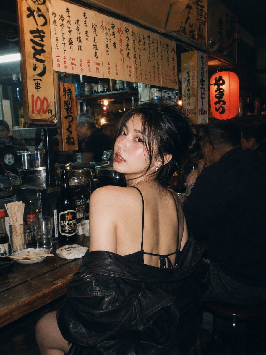 A beautiful young East Asian woman with long dark wavy hair and striki